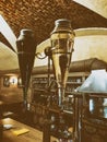 Beer taps to dispense beer in mug with selective focus and distillery in background of a brewery. Royalty Free Stock Photo