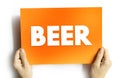 BEER text on card held by hands, concept of drink, beverage, party, and celebration Royalty Free Stock Photo