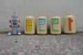 Beer text painted over beer cans with a tin toy robot Royalty Free Stock Photo