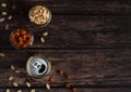 beer in a tin can on a wooden background with crackers and peanuts top view Royalty Free Stock Photo