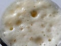 Beer from the top. Close-up of thick beer foam in a glass. Large and small bubbles Royalty Free Stock Photo