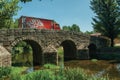 Beer truck passing over old bridge on the Sever River in Portagem