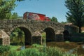 Beer truck passing over old bridge on the Sever River in Portagem