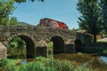 Beer truck passing over old bridge on the Sever River in Portagem