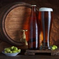 Beer with vintage old barrel and fresh hops for brewing