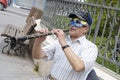 Beersheba, Israel. March 24, A man in a mask and cap playing the flute in Purim