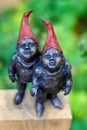 Beervelde, Belgium - October 13 2019: A top down portrait of two gnome statues made from metal. The steel gnomes are standing on a