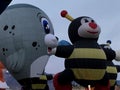 Bees accompanied by a penguin hot air balloon at Special Shapes Glow.