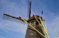 View on isolated wings of old windmill against blue sky Molen de grauwe beer Royalty Free Stock Photo