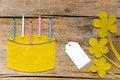 Beeswax, cake with candles and flowers on wooden table, empty si