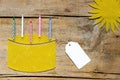 Beeswax, cake with candles and sun on wooden table, empty sign