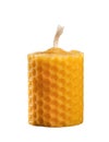 Beeswax candle displaying natural honeycomb texture on white Royalty Free Stock Photo