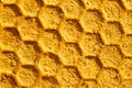 Beeswax pattern, golden honeycomb with a hexagon cell shape, beehive macro