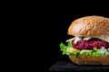 Beet burger with lettuce, cheese and yogurt sauce. Copy space