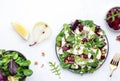 Beet, feta cheese and pear healthy salad with arugula, lamb lettuce, red onion, chard and walnut, white kitchen table. Fresh Royalty Free Stock Photo