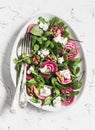 Beet and goat cheese salad on a light background, top view. Royalty Free Stock Photo