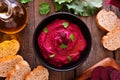 Beet hummus dip, overhead table scene with bread and ingredients on wood