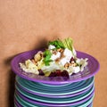 Beet salad with goat cheese, walnuts, greens and herbs and olive oil on a bright colorful ceramic plates stacked. Portion of salad Royalty Free Stock Photo