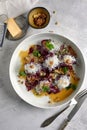 Beet salad with parmesan cheese, oranges and walnuts in a gray bowl. Health food. view from above