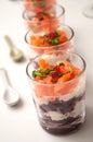 Beet and salmon appetizers in little glasses on white background