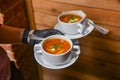 Beetroot and cabbage soup, borshch. Waiter serving dinner at restaurant or diner, eating out concept Royalty Free Stock Photo