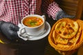 Beetroot and cabbage soup, borshch. Waiter serving dinner at restaurant or diner, eating out concept Royalty Free Stock Photo