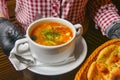 Beetroot and cabbage soup, borshch. Waiter serving dinner at restaurant or diner, eating out concept Royalty Free Stock Photo