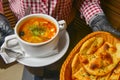 Beetroot and cabbage soup, borshch. Waiter serving dinner at restaurant or diner, eating out concept Royalty Free Stock Photo