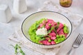 Beetroot dumplings or gnocchi with mashed green peas and curd cheese in a white plate on a light concrete background. Vegetarian Royalty Free Stock Photo