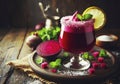 Beetroot juice in a glass and fresh organics beetroot with lemon and mint leaves on rustic wooden table Royalty Free Stock Photo