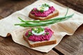 Beetroot mixed with goat cream cheese spreaded on whole grain bread. Royalty Free Stock Photo