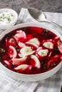 Beetroot red borsch with polish dumplings uszka closeup on the plate. Vertical Royalty Free Stock Photo