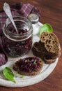 Beetroot relish and slices of rye bread on rustic wooden board. Healthy breakfast or snack. Royalty Free Stock Photo