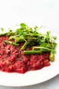 Beetroot risotto with rice and sesame seeds, baked asparagus with microgreens Royalty Free Stock Photo