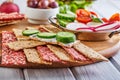 Beetroot and rye flour crackers with vegetables for making snacks on a wooden background. Vegetarianism and healthy Royalty Free Stock Photo