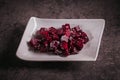 Beetroot salad on dark background. Cooked beets, oil and sesame seeds