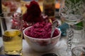 Beetroot salad on a table background of wine glasses and juice