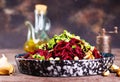 Beetroot salad with wallnuts and garlic in bowl on wooden table. Selective focus