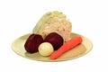 Beets, cabbage, onions, carrots lay on a plate