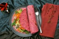 Red beet tortilla wraps filled with veggies as a healthy lunch