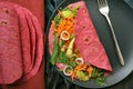 Red beet tortilla wraps filled with veggies as a healthy lunch