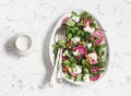 Beets salad with arugula, feta cheese and walnuts. On a light background Royalty Free Stock Photo