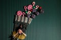 Befana sock with sweet coal and candy on dark greeen background. Italian Epiphany day tradition.