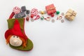 Befana sock with sweet coal and candy on white background. Italian Epiphany day tradition. Royalty Free Stock Photo