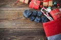 The Befana sock with sweet coal and candy on wooden background. Italian Epiphany day tradition.