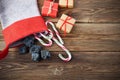 The Befana sock with sweet coal and candy on wooden background. Italian Epiphany day tradition. Royalty Free Stock Photo