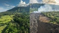 A beforeandafter comparison of a landscape with one side showing lush greenery and the other side scorched and buried by