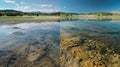 A beforeandafter comparison of a murky polluted lake transformed into a clear clean body of water thanks to a solar