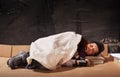 Beggar boy sleeping on cardboard sheet Royalty Free Stock Photo