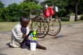 Beggar, disabled woman Sit for money from tourists. With a wheelchair on the street, while the sun is hot Royalty Free Stock Photo